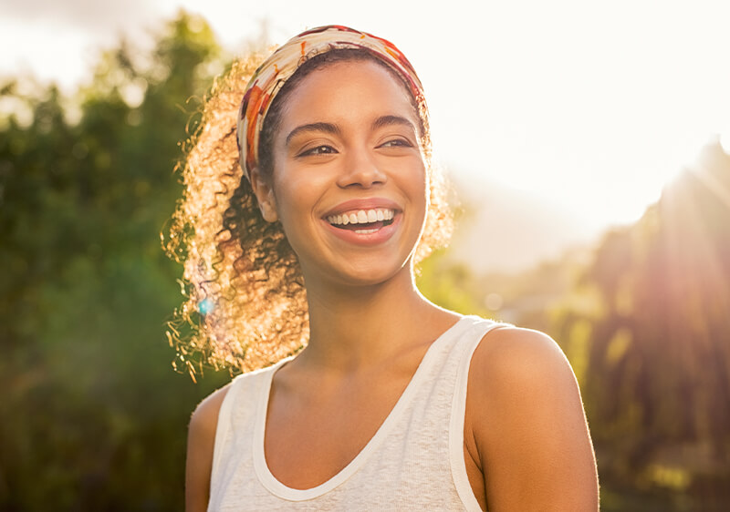 Woman smiling outside on a sunny day